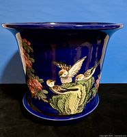 Full view of cobalt-blue planter with birds and underplate