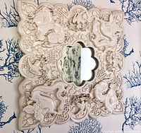 Front view of carved resin Chinese motif mirror