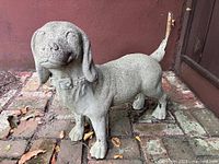 Full view of concrete dog statue front left side