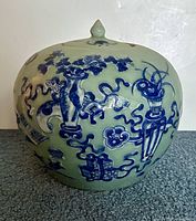 Front view showing jar with lid and blue symbolic decoration