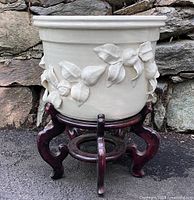 Full view of ceramic cachepot on rosewood stand