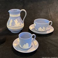 Group showing pitcher, teacup with saucer, straight-sided cup with saucer