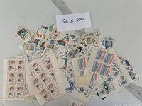 Overview of assorted 5-cent Canadian stamps spread out