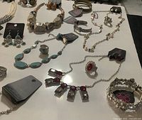 Assorted Paparazzi necklaces, bracelets, earrings and rings displayed