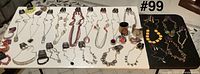 Overview of full lot on two tables showing necklaces with tags, matching earrings and bracelets.