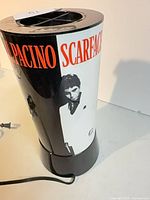 Front view of cylindrical Scarface lamp showing graphic and cord