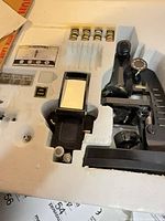 Microscope set in molded foam showing microscope, vials, slides and accessories