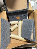 Box contents showing grey carpeted platforms and sisal posts