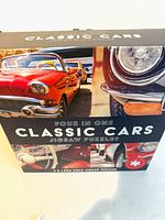 Front of box showing title, images of classic cars