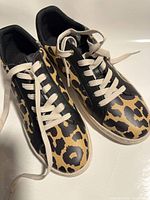 Top view showing leopard print uppers, laces, and overall condition