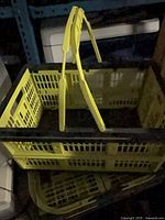 Top view of upright yellow and black folding basket showing handles and lattice sides