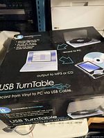 Front of sealed Innovative Technology USB Turntable box showing product image and key features