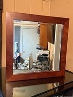 Front view showing mirror and wood frame