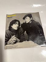 Front of picture sleeve showing John Lennon and Yoko Ono, title Woman