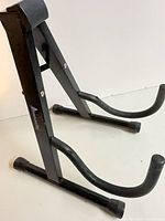 Full view of Pinnacle A-frame guitar stand showing structure and brand label