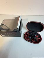 Earphones in case next to retail box