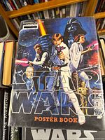 Cover of The Star Wars Poster Book showing classic trilogy artwork