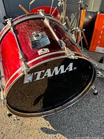Red Tama bass drum with logo head and hardware visible