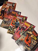 Five Twilight Zone Gold Key comics fanned out on tabletop