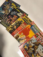 Front covers of all six comic books laid side-by-side showing titles, artwork and general condition