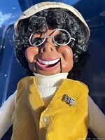 Front view of dummy showing head, glasses, vest, pin