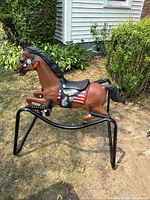 Full view of rocking horse on frame