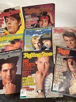 Front view of eight vintage Rolling Stone magazines fanned out to show cover subjects and condition