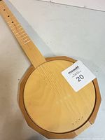 Full view of wooden ukulele round body and neck