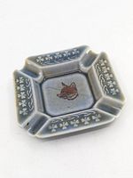 Top view of hexagonal blue ceramic ashtray with fox motif and clover border