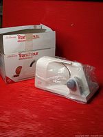 Food slicer in plastic beside original box