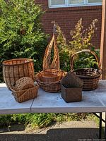 Group of assorted wicker baskets on table