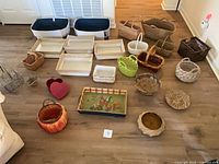 Full layout of assorted baskets, trays, bins on floor