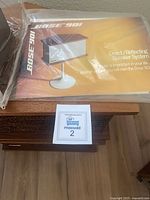 Manual on top of speaker cabinet showing Bose 901 branding