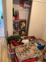 Overview of closet area with totes, boxed lights and décor