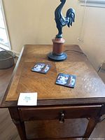 End table top with rooster lamp and coasters