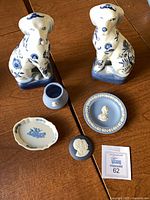 Full lot showing dog figurines, Wedgwood pieces and cream dish