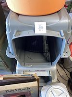 Open grey Petmate kennel with white food container and boxed pet door visible