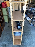 Side view highlighting shelves and spindle supports