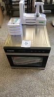 Front view of Cosori dehydrator, spiralizer and blade cases on top