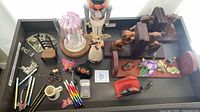 Entire drawer view showing all items including nutcracker, angel, bookends, pens, cloche, etc.