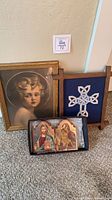 Overall lot showing framed child portrait, framed Celtic cross needlepoint, boxed Orthodox icon diptych