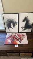 Overview of all three horse artworks on table