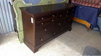 Front and top view of dark wood dresser