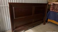 Headboard showing paneled design and wood finish