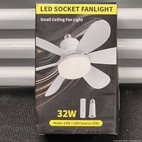 Retail packaging showing LED socket fan light, wattage details, remote and socket adapter
