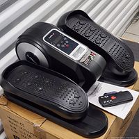 Elliptical machine on box with remote and manual visible