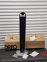 Fan assembled with box, remote, hardware and manuals visible