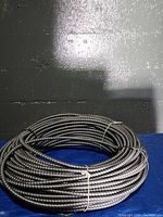 Full coil of metal-clad cable on surface