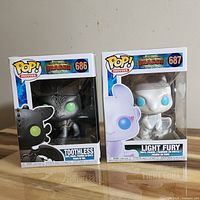 Front view of both boxed Funko Pop figures