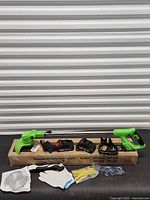 Full kit laid out: trimmer, batteries, charger, blades, gloves, glasses